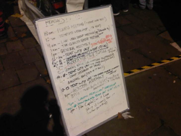 A whiteboard with a daily schedule of events in the camp.